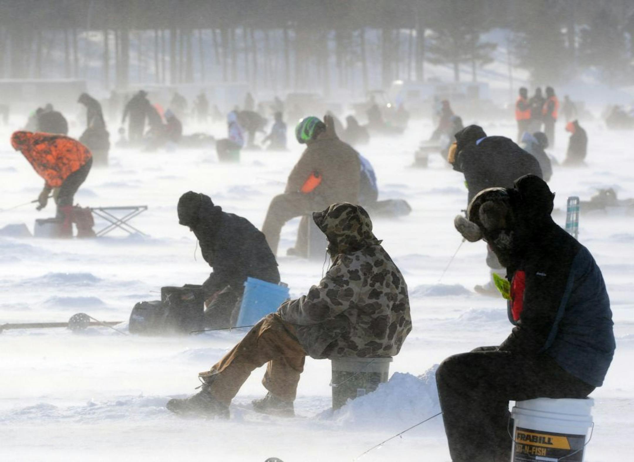 Approximately 10,000 ice fishing anglers brave high winds and snow to fish in the 23rd annual Brainerd Jaycees Ice Fishing Extravaganza on Saturday, Jan. 19, 2013 on Gull Lake near Nisswa, Minnesota. Proceeds from the tournament benefit Confidence Learning Center and other local charities.