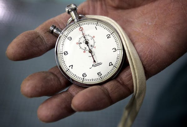 CARLOS GONZALEZ � cgonzalez@startribune.com An analog Minerva stopwatch held by swimming coach Art Downey, who is in his 50th year coaching the Edin