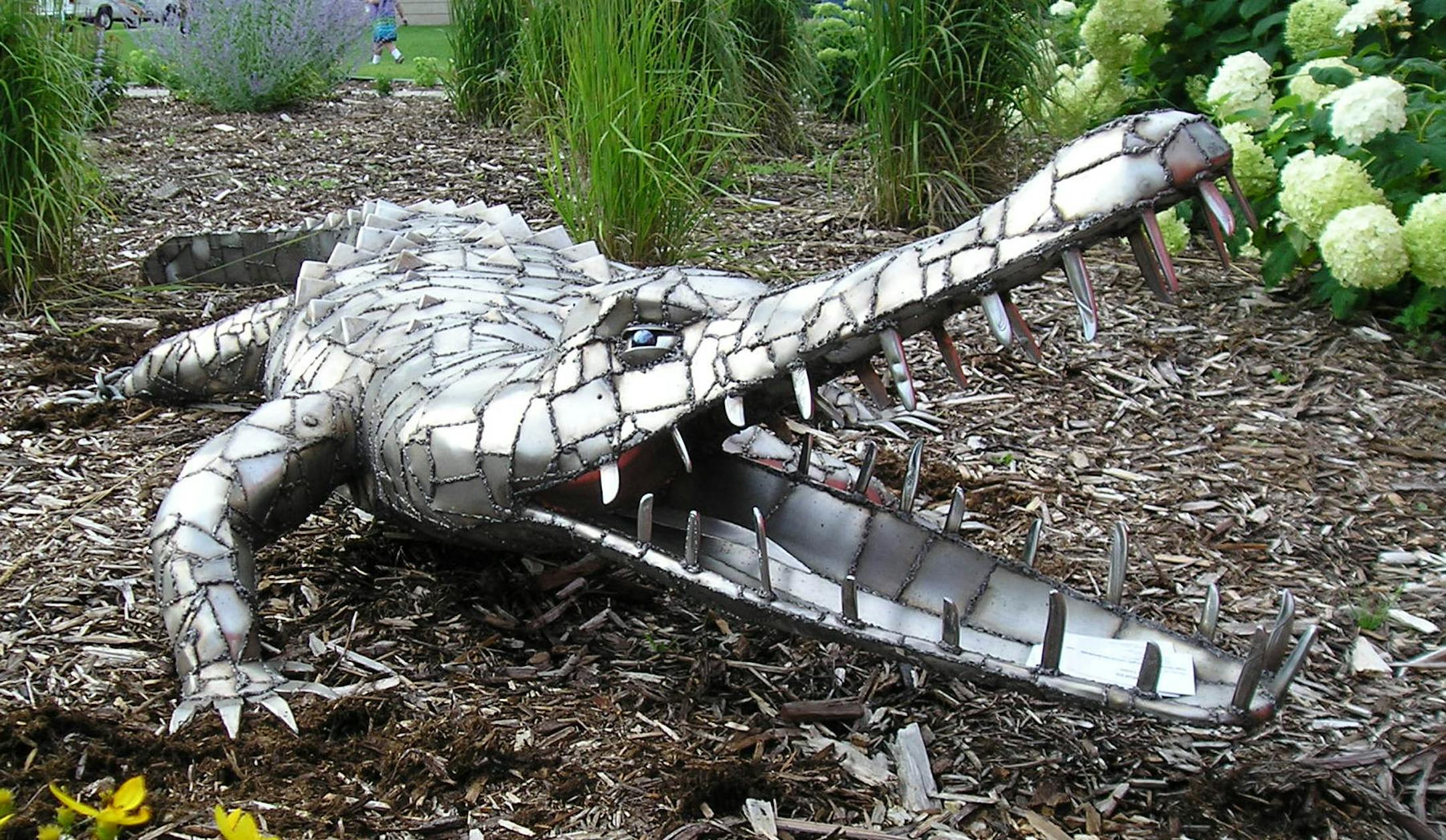 Dale Lewis made his crocodile sculpture by welding together scrap pieces of stainless steel. The teeth are made from butter knives.