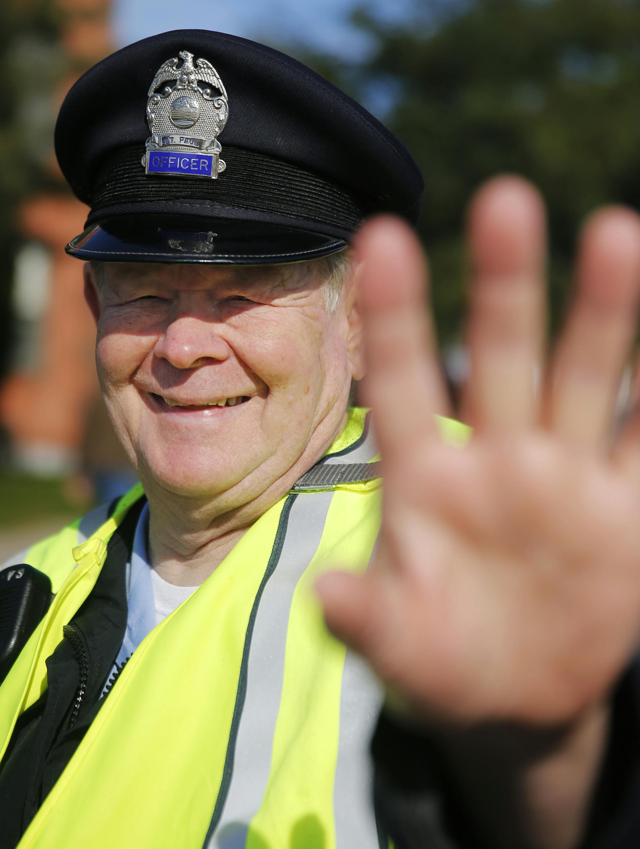 Near the finish of the Medtronics Twin Cities Marathon, Pat Willis directs traffic. He graduated from St. Paul Central High School in 1958. He married his wife, Peggy, 50 years ago this past August. He turns 75 next month. and has been an officer with the St. Paul Police Reserves since 1967.] Richard Tsong-Taatarii/rtsong-taatarii@startribune.com