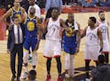 Golden State Warriors' Kevin Durant (35) walks off the court after sustaining an injury as Toronto Raptors' Serge Ibaka (9) addresses the crowd, while
