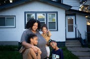 Arianna Anderson with her children Zion Anderson-Thomas, 9, Zaila Anderson-Thomas, 2, and Zaniyah Anderson-Thomas, 6, in front of the troubled house s