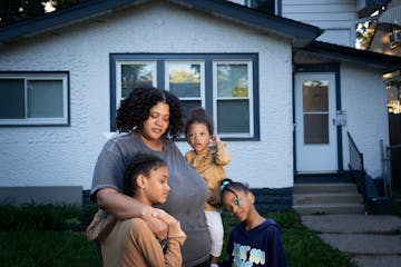 Arianna Anderson with her children Zion Anderson-Thomas, 9, Zaila Anderson-Thomas, 2, and Zaniyah Anderson-Thomas, 6, in front of the troubled house s