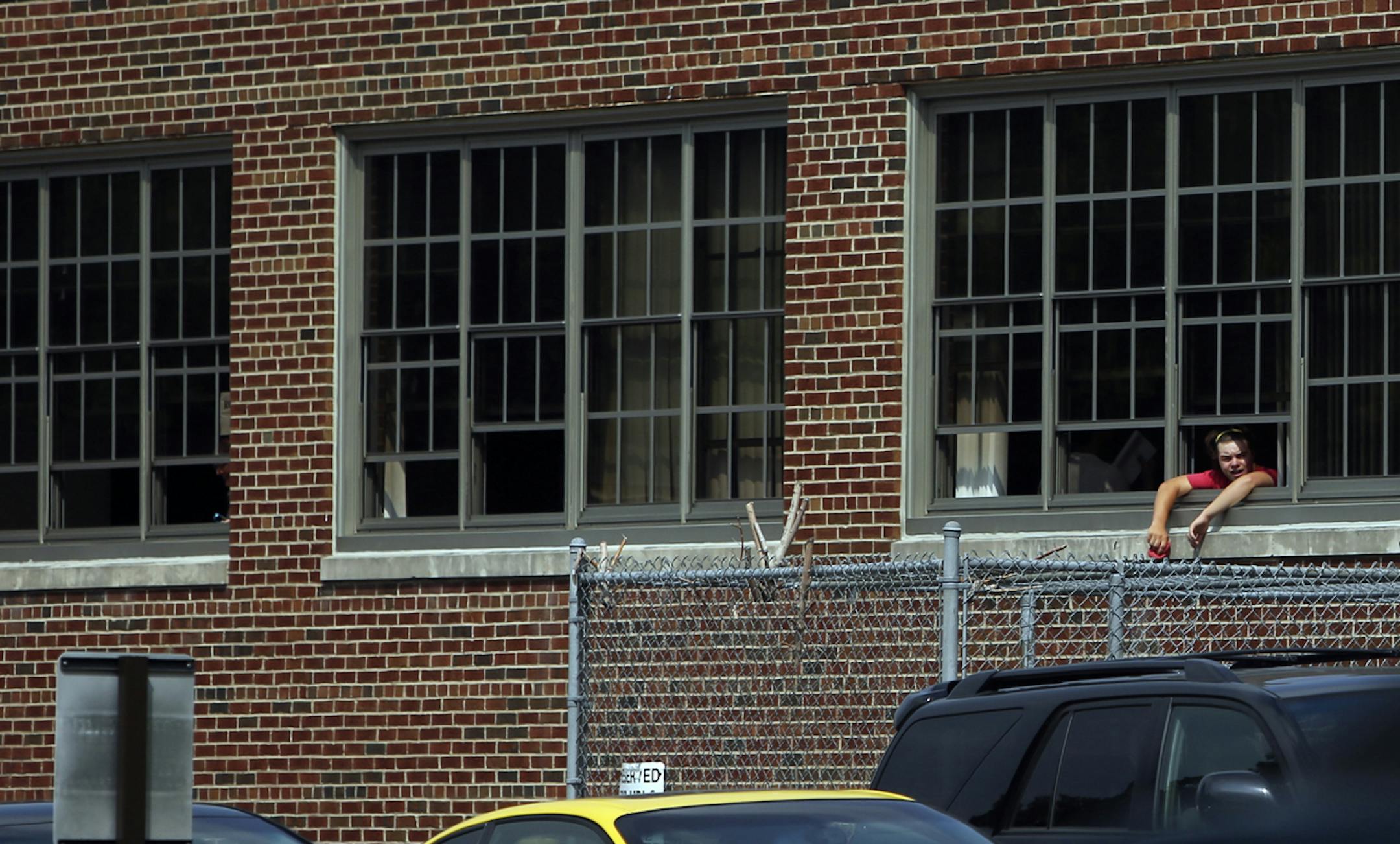 A student hung his head out a window at Patrick Henry High School Tuesday, Aug. 27, 2013](DAVID JOLES/STARTRIBUNE) djoles@startribune.com Minneapolis and area school students suffered through yet another day of brutal heat, many without the benefit of air conditioning. A protest of the hot learning conditions and press conference was held at Patrick Henry High School, following classes Tuesday, Aug. 27, 2013 organized by the Minneapolis teachers union and Neighborhoods organizing for Change. A f