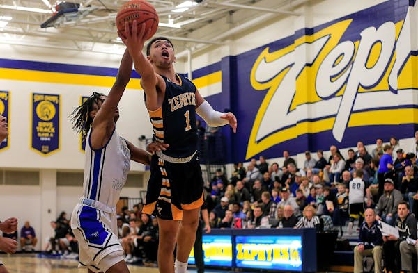 Mahtomedi's J'Vonne Hadley drove to the basket during a 37-point performance against Tartan.