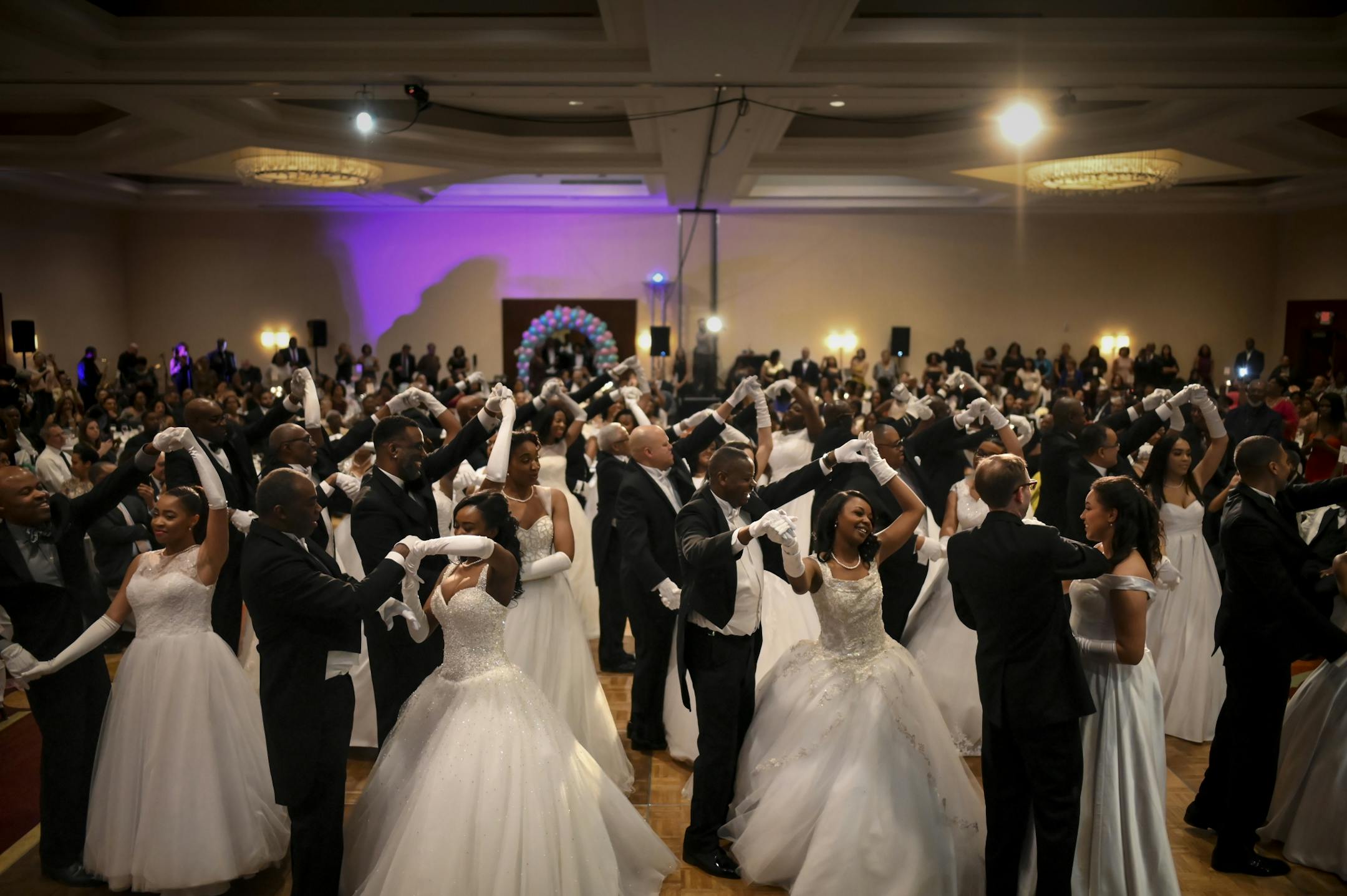 Fathers and senior escorts danced with their debutante daughters at Saturday night's winter cotillion ball. They were dancing to "Unforgettable" by Irving Gordon.