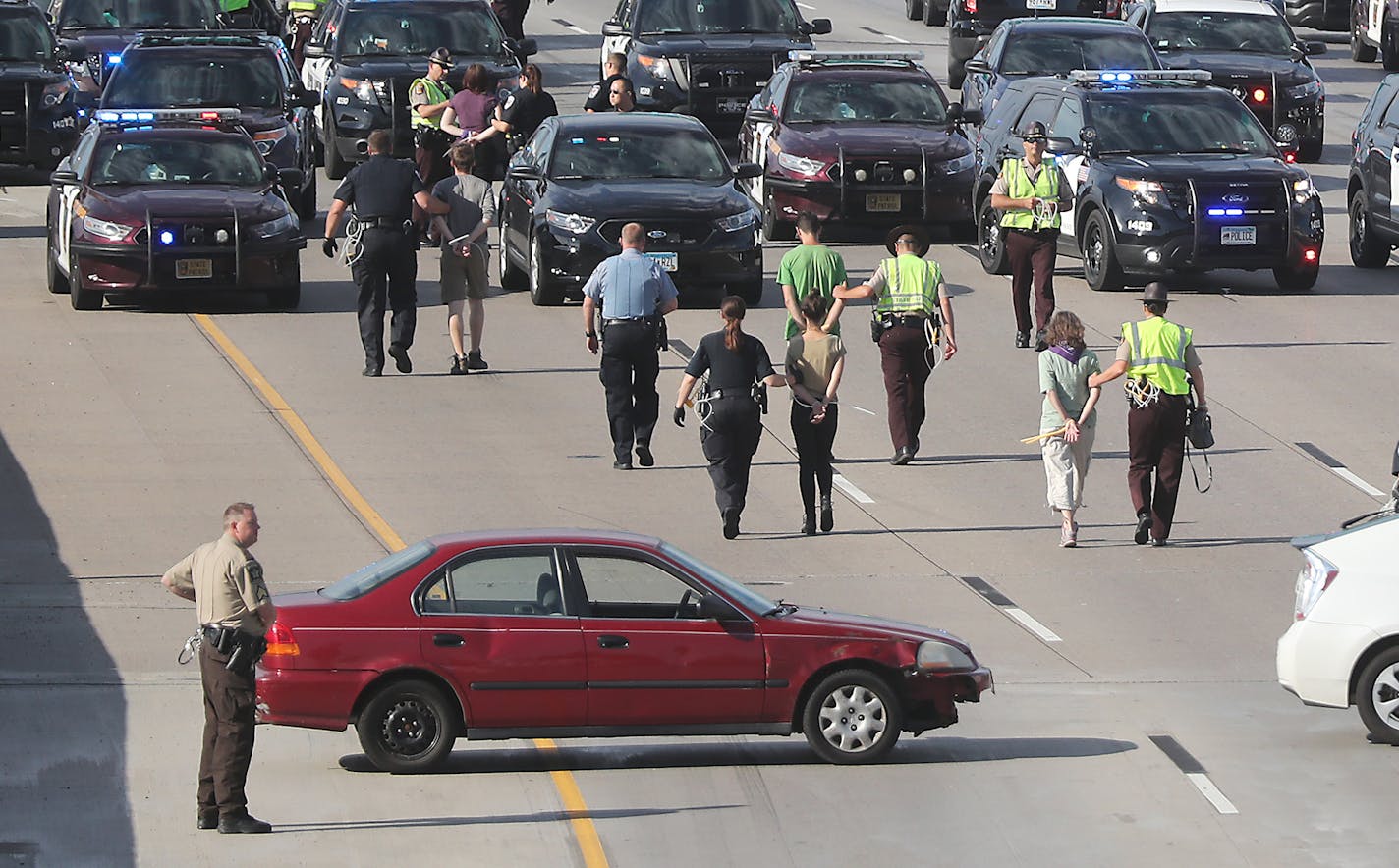 Protestors blocked and were arrested on the southbound interstate on 35W near the University Avenue bridge, Wednesday, July 13, 2016 in Minneapolis, MN. ] (ELIZABETH FLORES/STAR TRIBUNE) ELIZABETH FLORES &#x2022; eflores@startribune.com