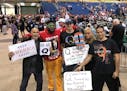Donald Trump supporters who are proponents of the "QAnon" conspiracy theory pose for a photo after Trump spoke at a MAGA rally at the Florida State Fa