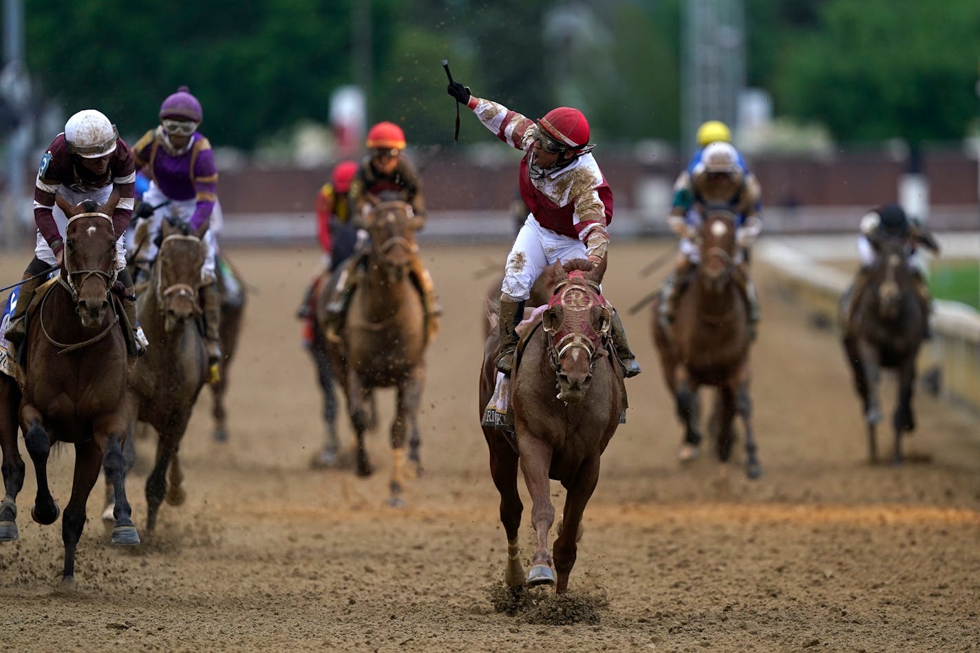 Sonny Leon celebrates after riding Rich Strike past the finish line to win the 148th running of the Kentucky Derby at Churchill Downs on Saturday