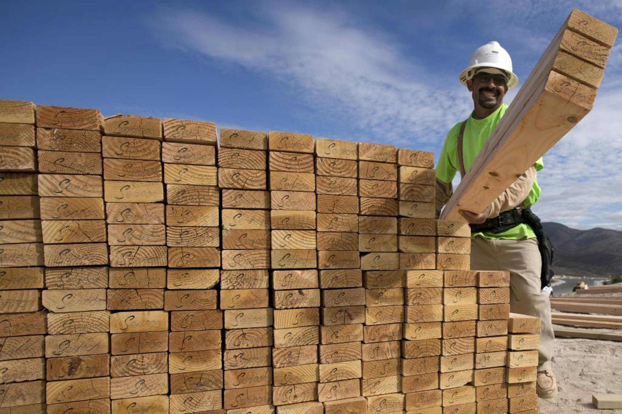 In this Friday, Nov. 16, 2012, photo, construction worker Miguel Fonseca carries lumber as he works on a house frame for a new home, in Chula Vista, Calif. U.S. builders broke ground on fewer homes in November after starting work in October at the fastest pace in four years. Superstorm Sandy likely slowed starts in the Northeast. The Commerce Department said Wednesday, Dec. 19, 2012, that builders began construction of houses and apartments at a seasonally adjusted annual rate of 861,000. That w