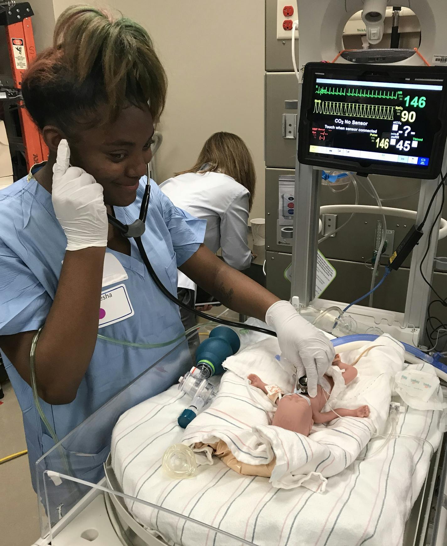 A high school student practices caring for a premature baby in a training room that resembles the neonatal intensive-care unit at Children&#xed;s Hospital in Minneapolis. Teens and their mentors with Big Brothers, Big Sisters of the Greater Twin Cities took the interactive tour and training in March.
Credit: Big Brothers, Big Sister of the Greater Twin Cities