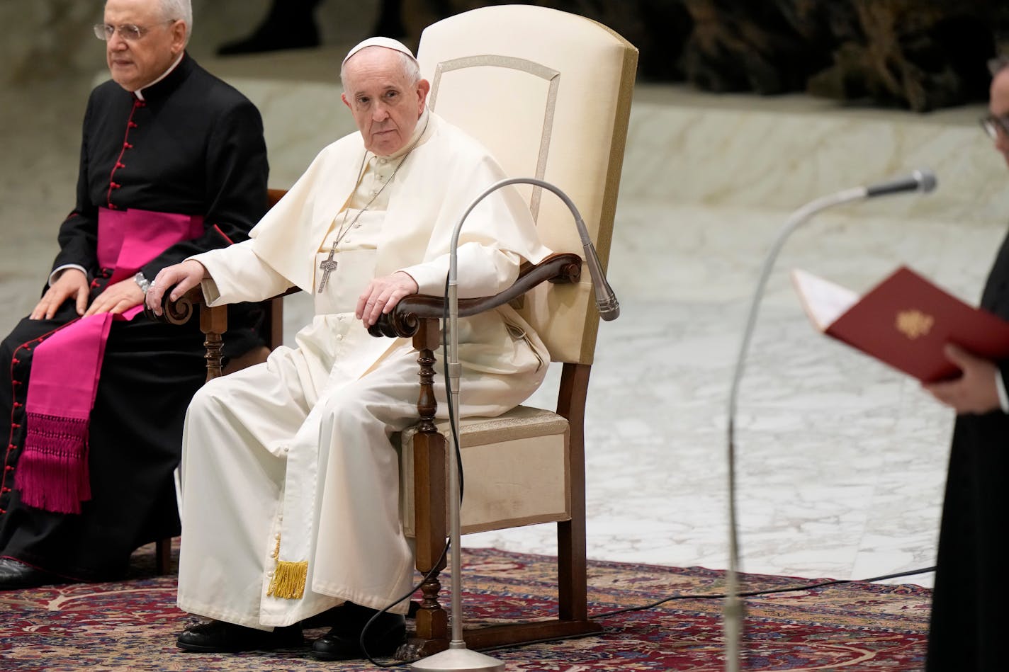 Pope Francis, flanked by Mons. Leonardo Sapienza, left, listens to greetings being read out in different languages during his weekly general audience in Paul VI hall, at the Vatican, Wednesday, Sept. 8, 2021. (AP Photo/Andrew Medichini)