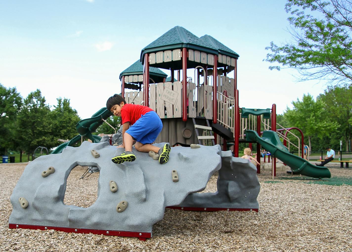 William Sanchez, 5, of Bloomington, plays at the new Burnsville Lions Playground at Cliff Fen Park in Burnsville. The new play area was started in May of 2015. A splash pad currently is under construction on the grounds.