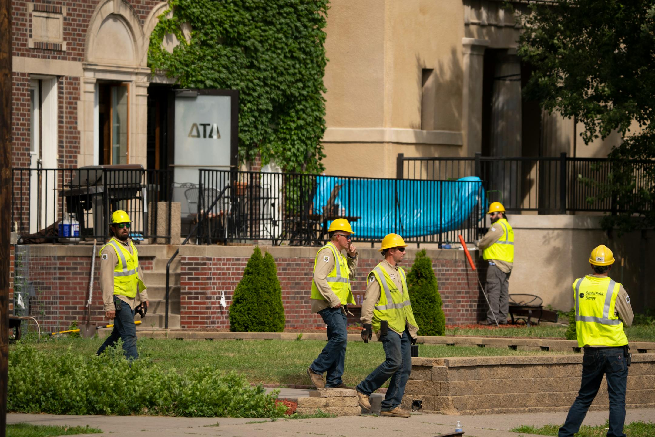 CenterPoint Energy personnel outside the fraternity house on University Ave. where a gas leak was first suspected Thursday afternoon in Minneapolis. A suspected gas leak resulted in the evacuation of fraternity houses on University Ave. SE across from the U of M campus.