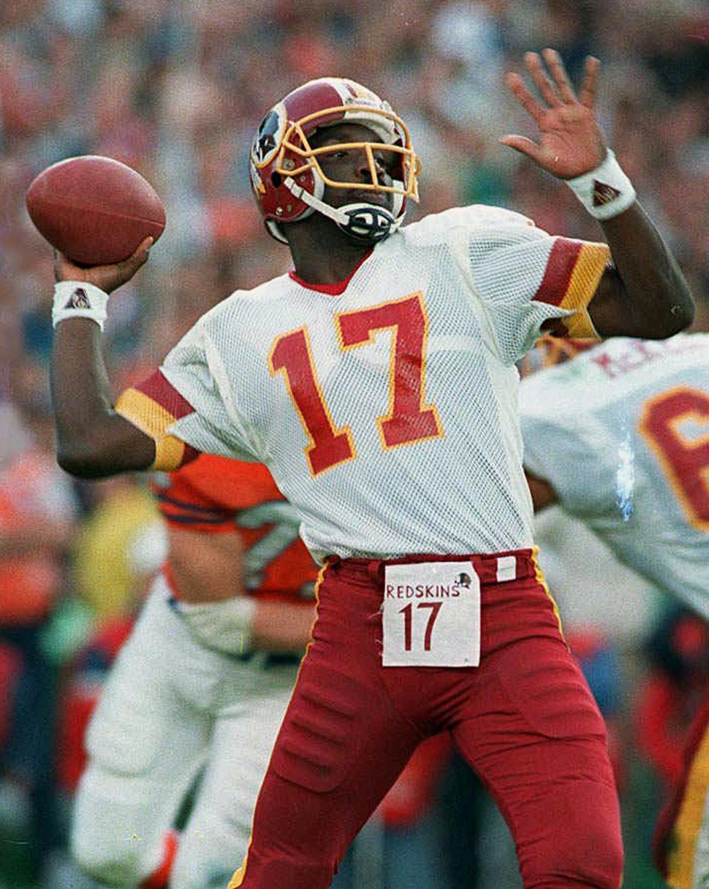 FILE - In this Jan. 31, 1988, file photo, Washington Redskins quarterback Doug Williams prepares to pass during the first quarter of Super Bowl XXII against the Denver Broncos in San Diego. Williams is one of 13 quarterbacks to start in a Super Bowl after not starting the regular season opener for his team. (AP Photo/Elise Amendola, File)