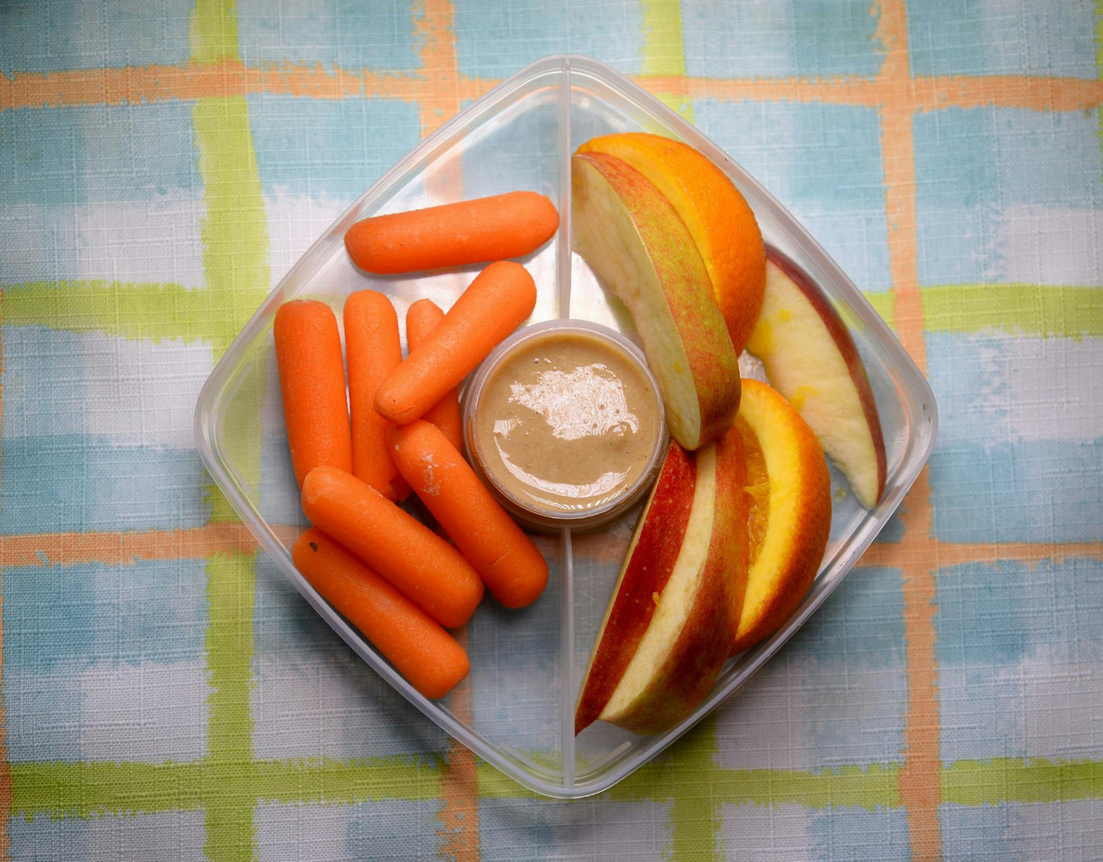 Salted Tahini Spread is an easy dip with carrots and apple slices. Oranges will keep the apples from turning brown too fast. (Diedra Laird/Charlotte Observer/TNS) ORG XMIT: 1189009