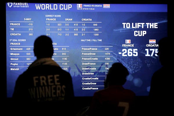 A board shows the World Cup soccer tournament odds as people look at information at the Meadowlands Racetrack on July 14, 2018, in East Rutherford, N.