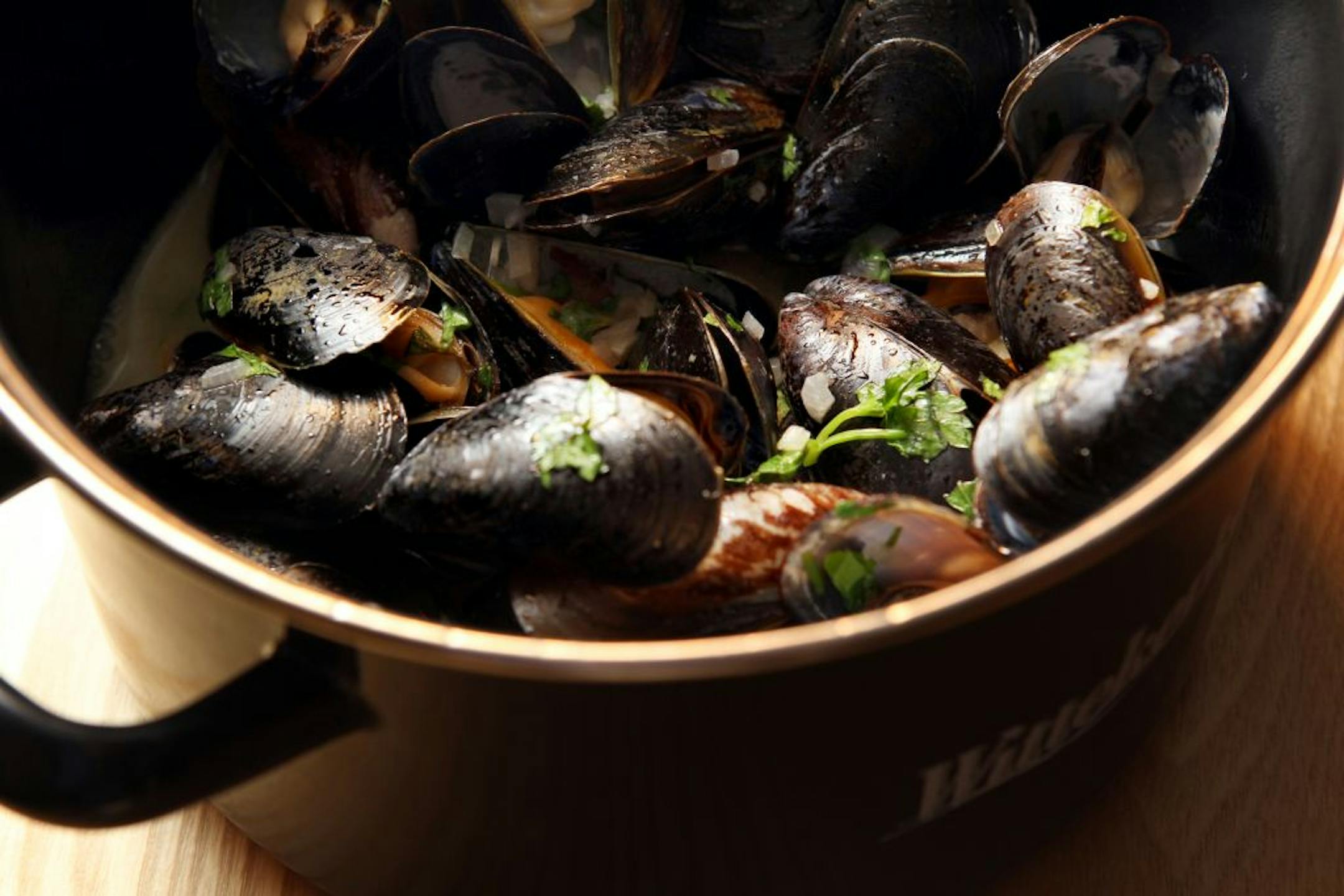 Moules Frites is mussels steamed with Wittekerke beer and bacon and served with fries at Pig & Fiddle in Edina. Photographed with a Belgian beer, the Tripel Karmeliet, January 12, 2012.