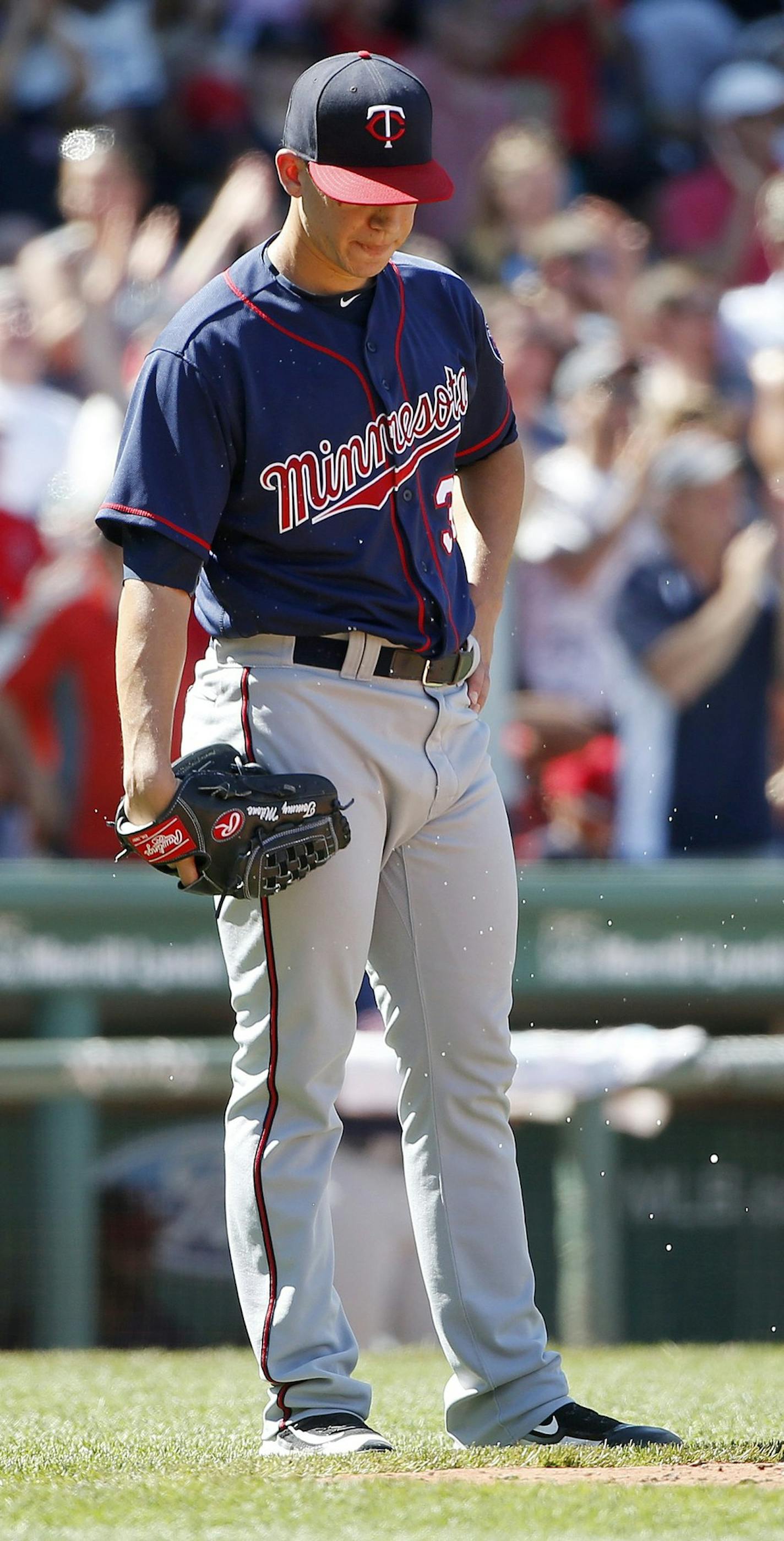 Minnesota Twins' Tommy Milone loooks down after giving up a three-run home run to Boston Red Sox's Travis Shaw during the fifth inning of a baseball game in Boston, Sunday, July 24, 2016. (AP Photo/Michael Dwyer)