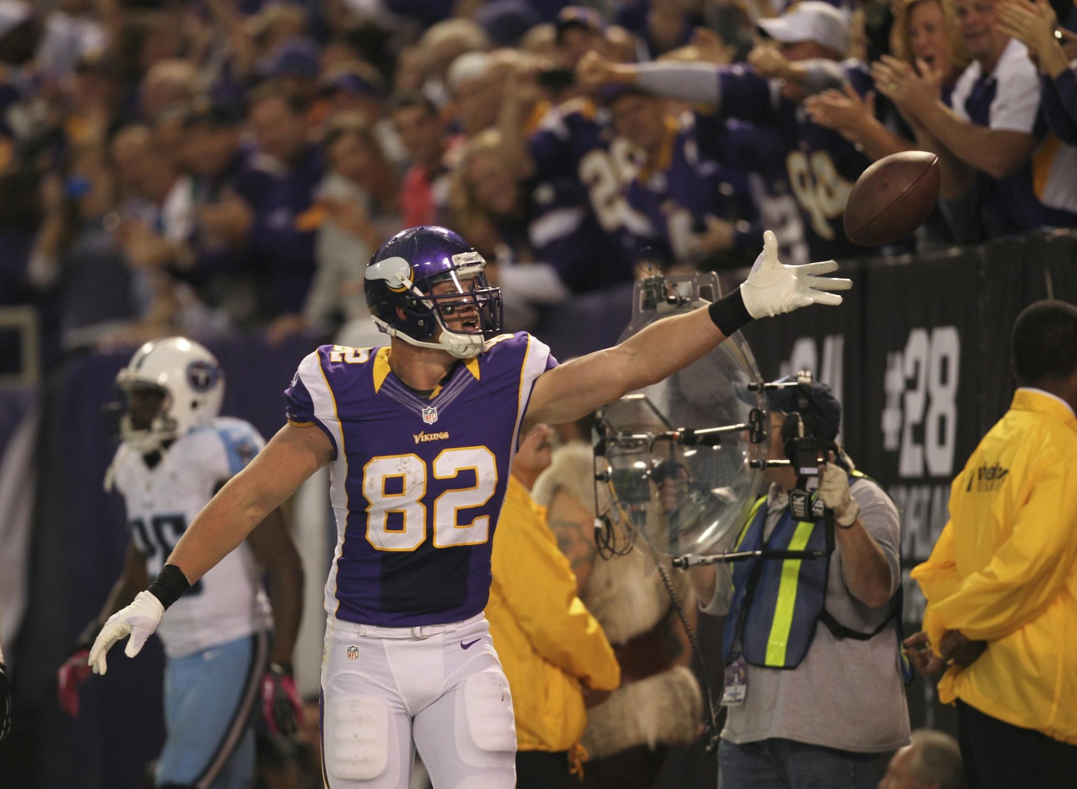 Vikings tight end Kyle Rudolph tossed the ball to a fan in the stands after he caught a fourth-quarter touchdown pass against the Titans on Sunday.