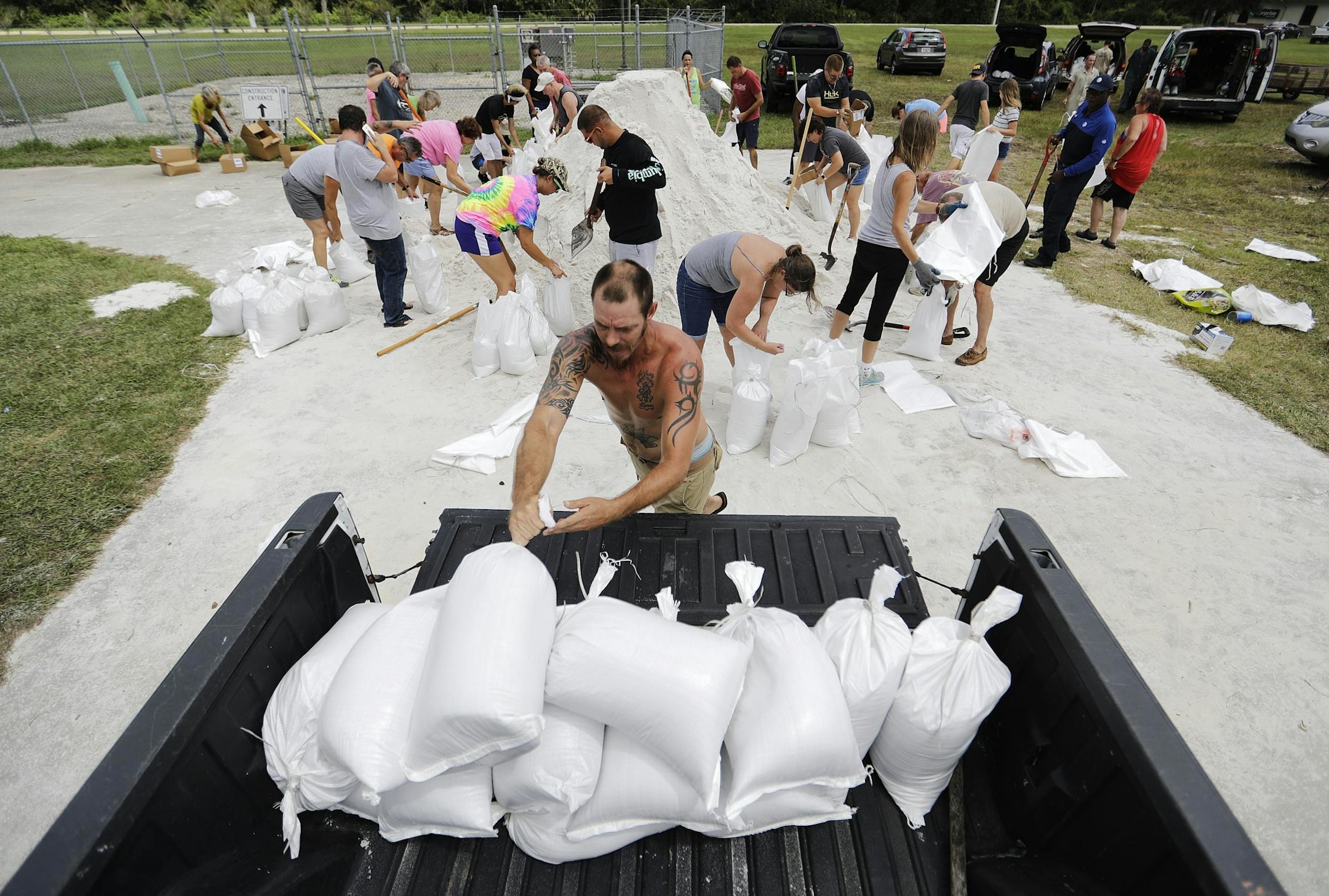 Ryan Kaye loads sandbags into his truck at a makeshift filling station provided by the county as protection ahead of Hurricane Irma, Friday, Sept. 8, 2017, in Palm Coast, Fla.