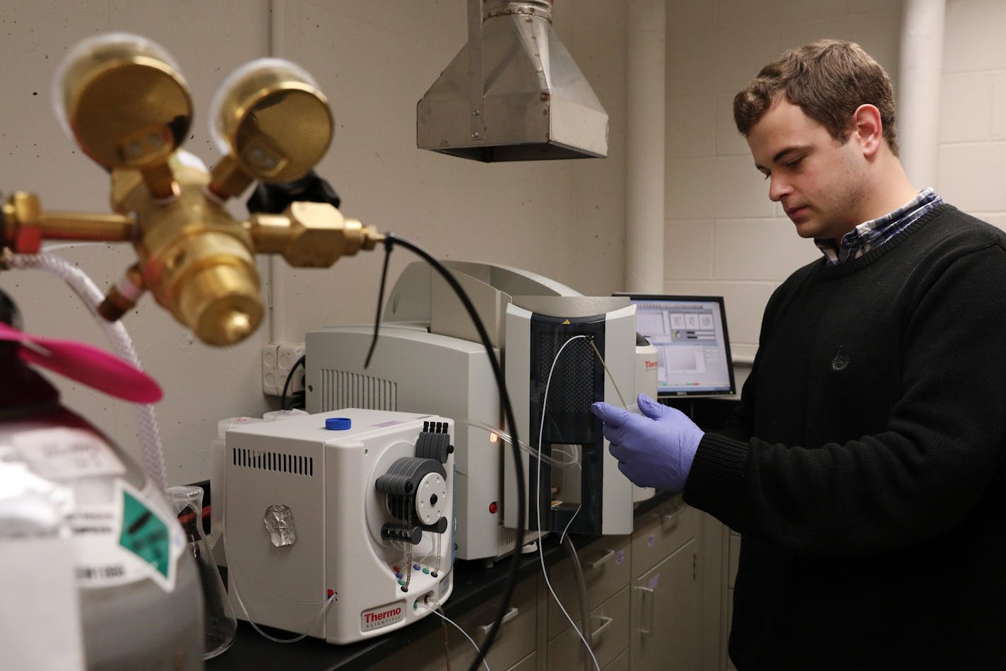 Graduate student John Brockgreitens measured contaminants with an atomic absorption spectrometer during an experiment in their lab.