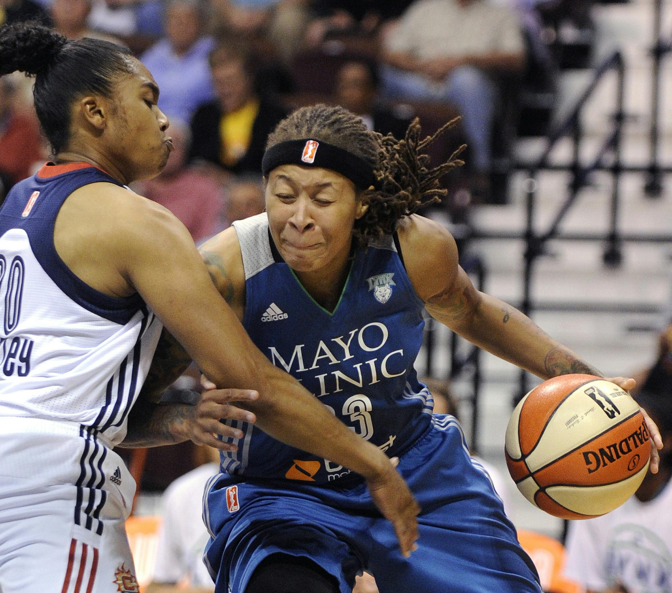 Minnesota Lynx's Seimone Augustus (33) drives past Connecticut Sun's Alex Bentley (20) during the second half of Minnesota's 85-79 victory in a WNBA basketball game in Uncasville, Conn., on Tuesday, July 14, 2015. (AP Photo/Fred Beckham)