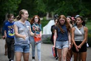 Student worker Leah Wasson, left, led a group of prospective students on a campus tour at Macalester College in St. Paul in June.