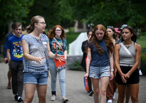 Student worker Leah Wasson, left, led a group of prospective students on a campus tour at Macalester College in St. Paul in June.