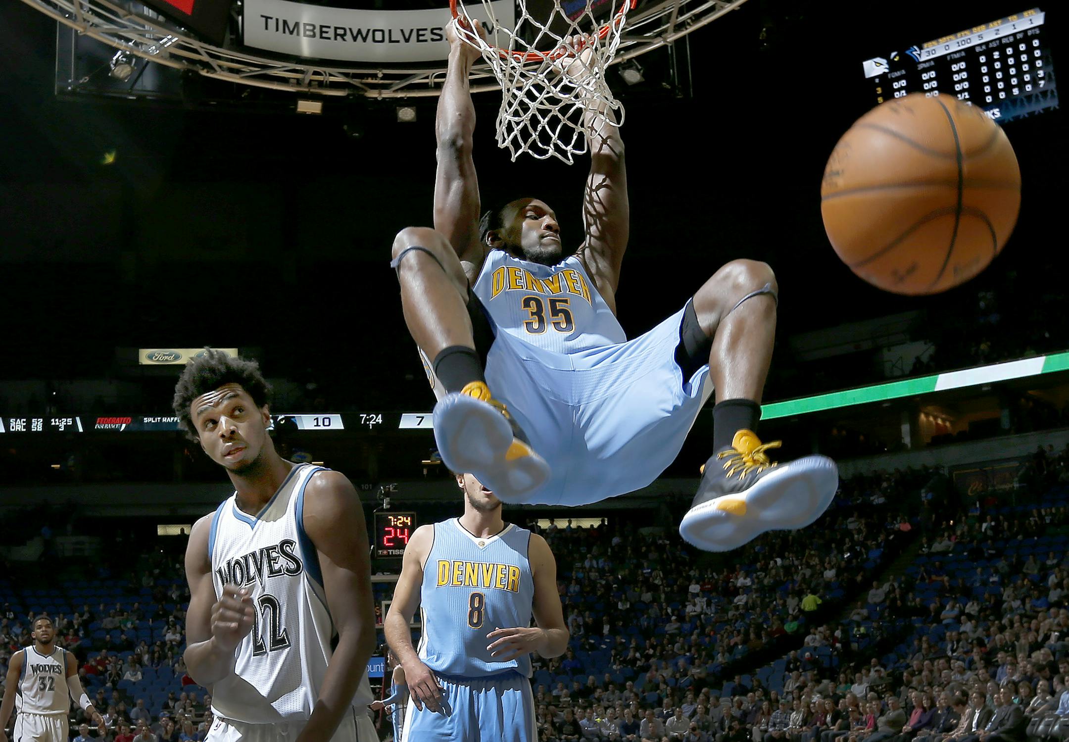 Kenneth Faried (35) dunked the ball while being defended by Andrew Wiggins (22) in the first half. ] CARLOS GONZALEZ cgonzalez@startribune.com - November 3, 2016, Minneapolis, MN, Target Center, NBA, Minnesota Timberwolves vs. Denver Nuggets