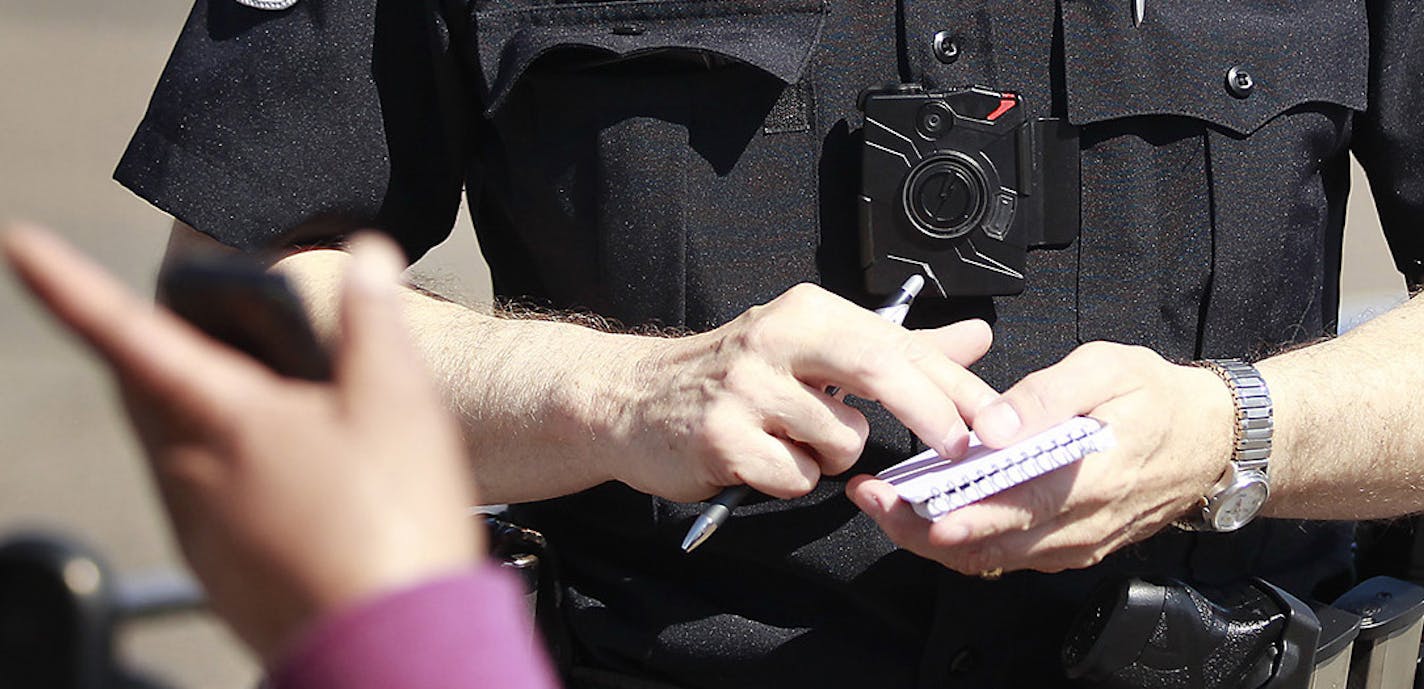 Columbia Heights police officer Terry Nightingale made sure to turn on his body cam before talking a pedestrian for dangerously crossing the street, Friday, April 17, 2015 in Columbia Heights, MN.