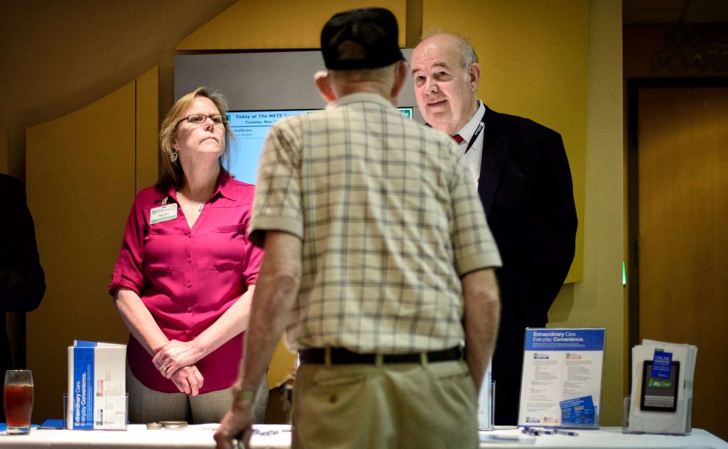 Nancy Henry and George Wietmarschen of St. Elizabeth Healthcare distributed information about their hospital during the Mayo Clinic event where Mayo cardiac electrophysiologist Dr. Christopher McLeod spoke in Erlanger, Ken., as part of the arrangement between Mayo and St. Elizabeth Healthcare.