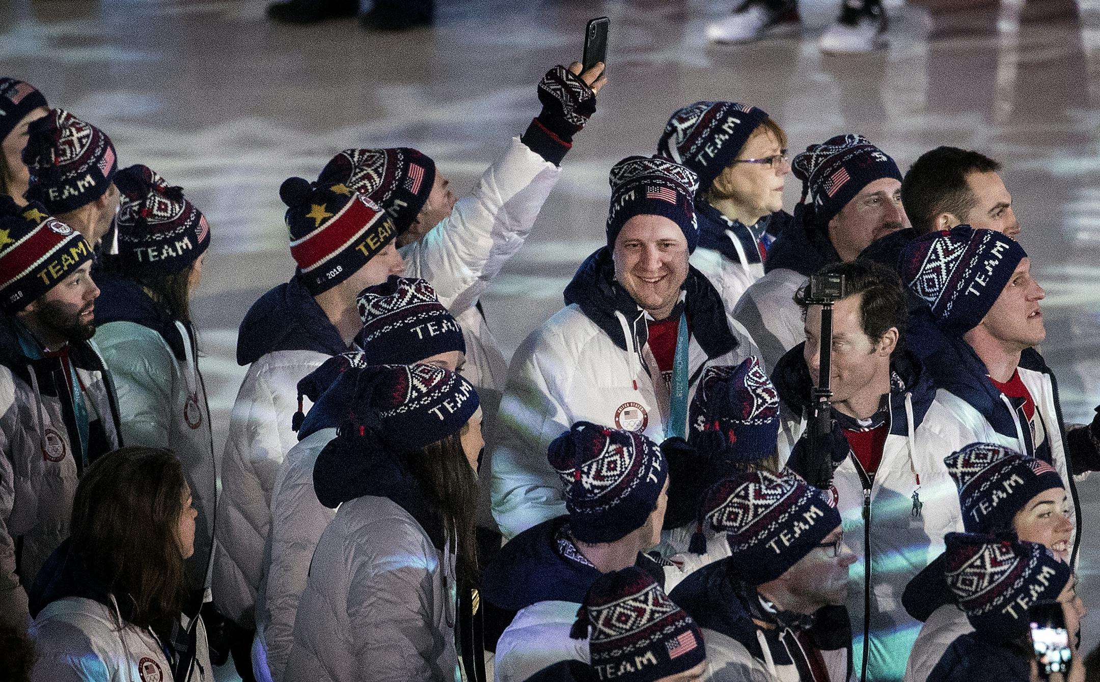 John Shuster (middle) and team USA entered Pyeongchang Olympic Stadium during Closing Ceremony on Sunday.