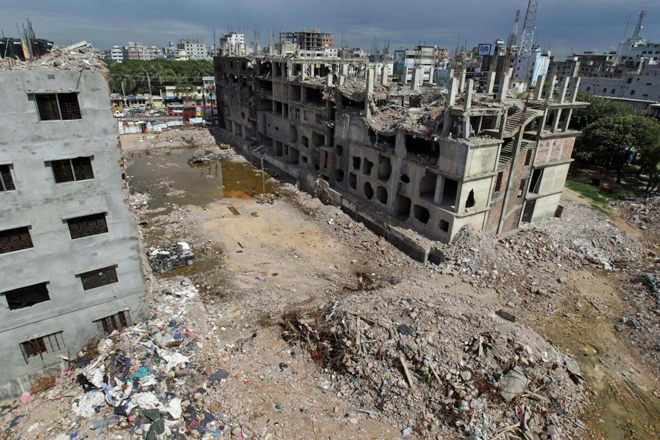 An overview of the site where a Bangladesh garment-factory building collapsed on April 24 killing 1,129 people in Savar, near Dhaka, Bangladesh, Thursday, June 13, 2013. Bangladeshi garment factories are routinely built without consulting engineers. Many are located in commercial or residential buildings not designed to withstand the stress of heavy manufacturing. Some add illegal extra floors atop support columns too weak to hold them, according to a survey of scores of factories by an engineer