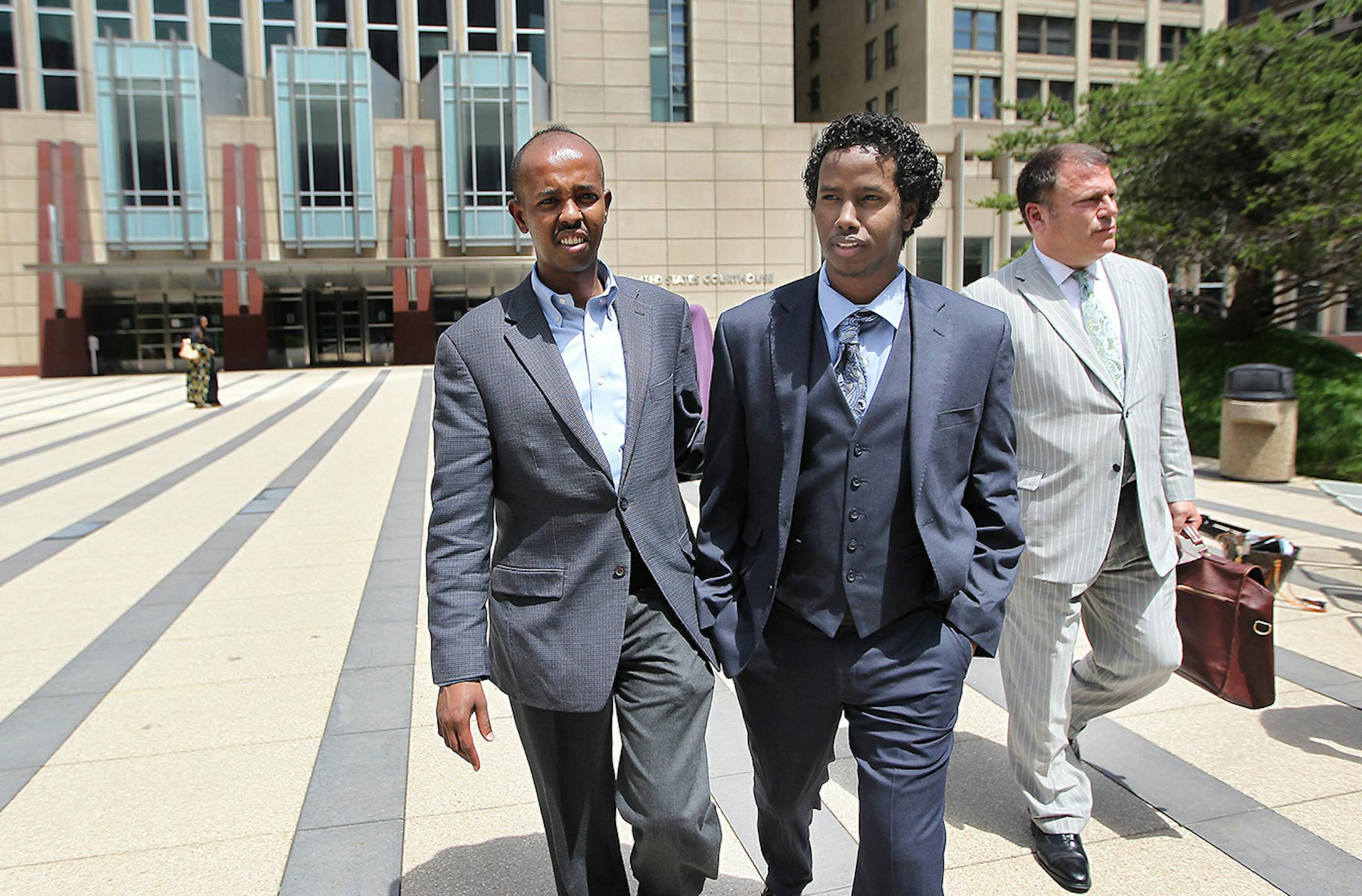 After spending seven months in federal detention, Mohamed Ali Omar, 21, walked outside the federal courthouse a free man with an interpreter. left, and his attorney Paul Applebaum, right, Tuesday, June 9, 2015 in Minneapolis, MN.