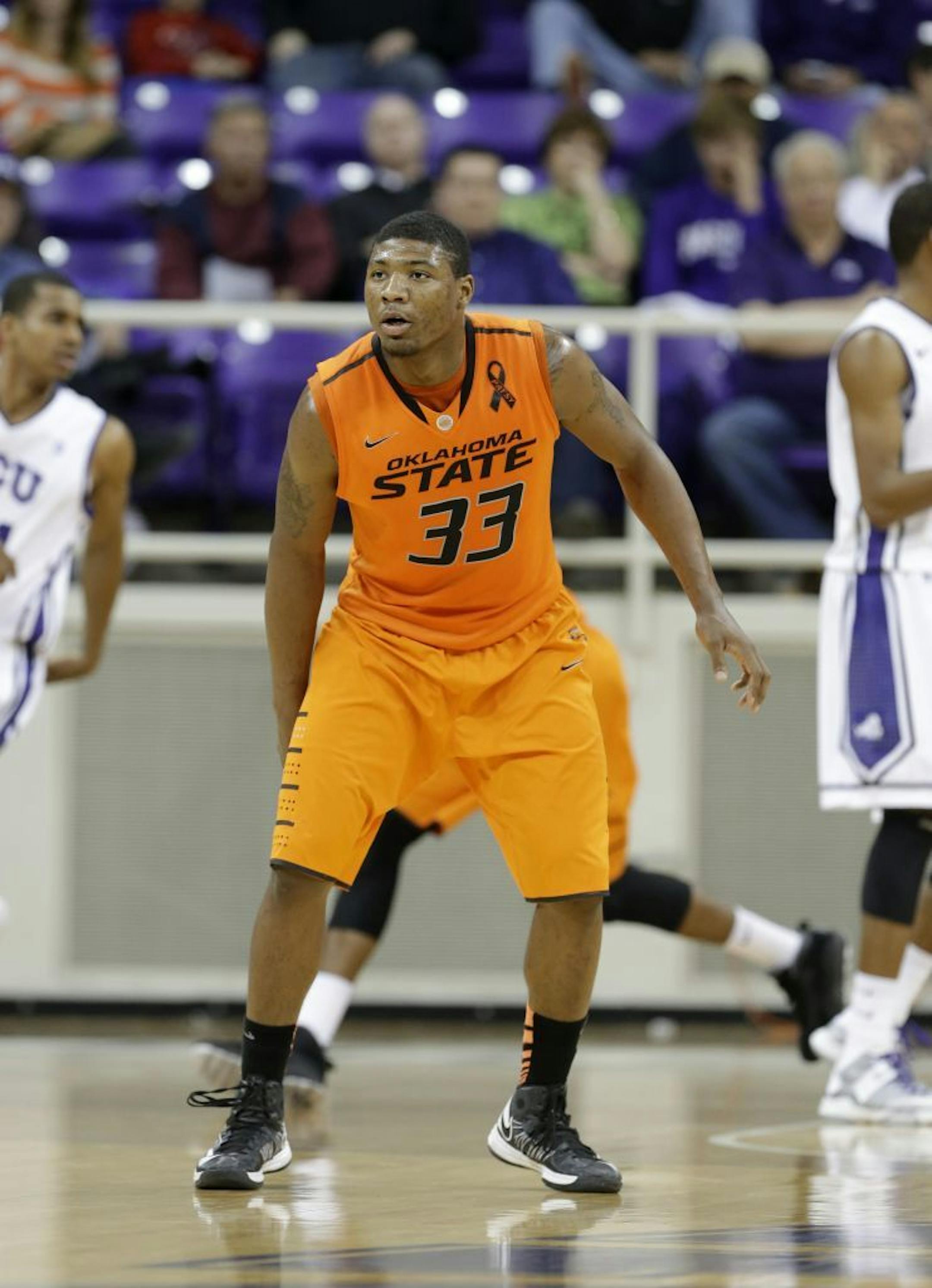 Oklahoma State's Marcus Smart (33) defends during an NCAA college basketball game against TCU Wednesday, Feb. 27, 2013, in Fort Worth, Texas. Oklahoma State won 64-47.