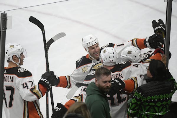 Teammates celebrated with Anaheim Ducks right wing Corey Perry (10) after his third period goal against the Minnesota Wild.