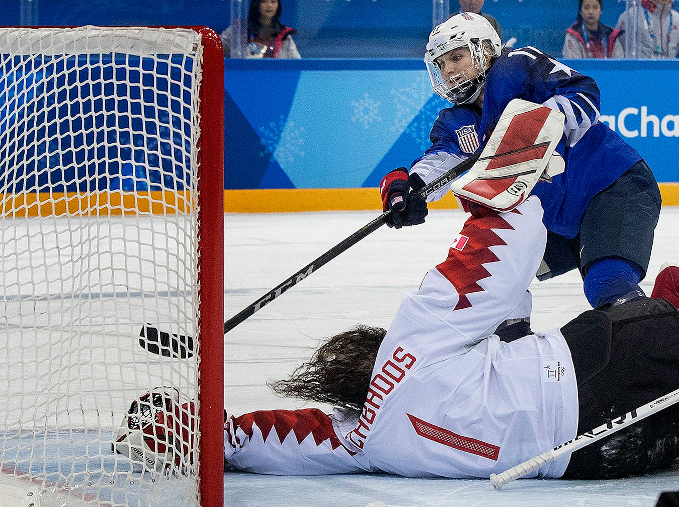 Jocelyne Lamoureux-Morando (17) shot the puck past Canada goalie Shannon Szabados (1) during the shootout.