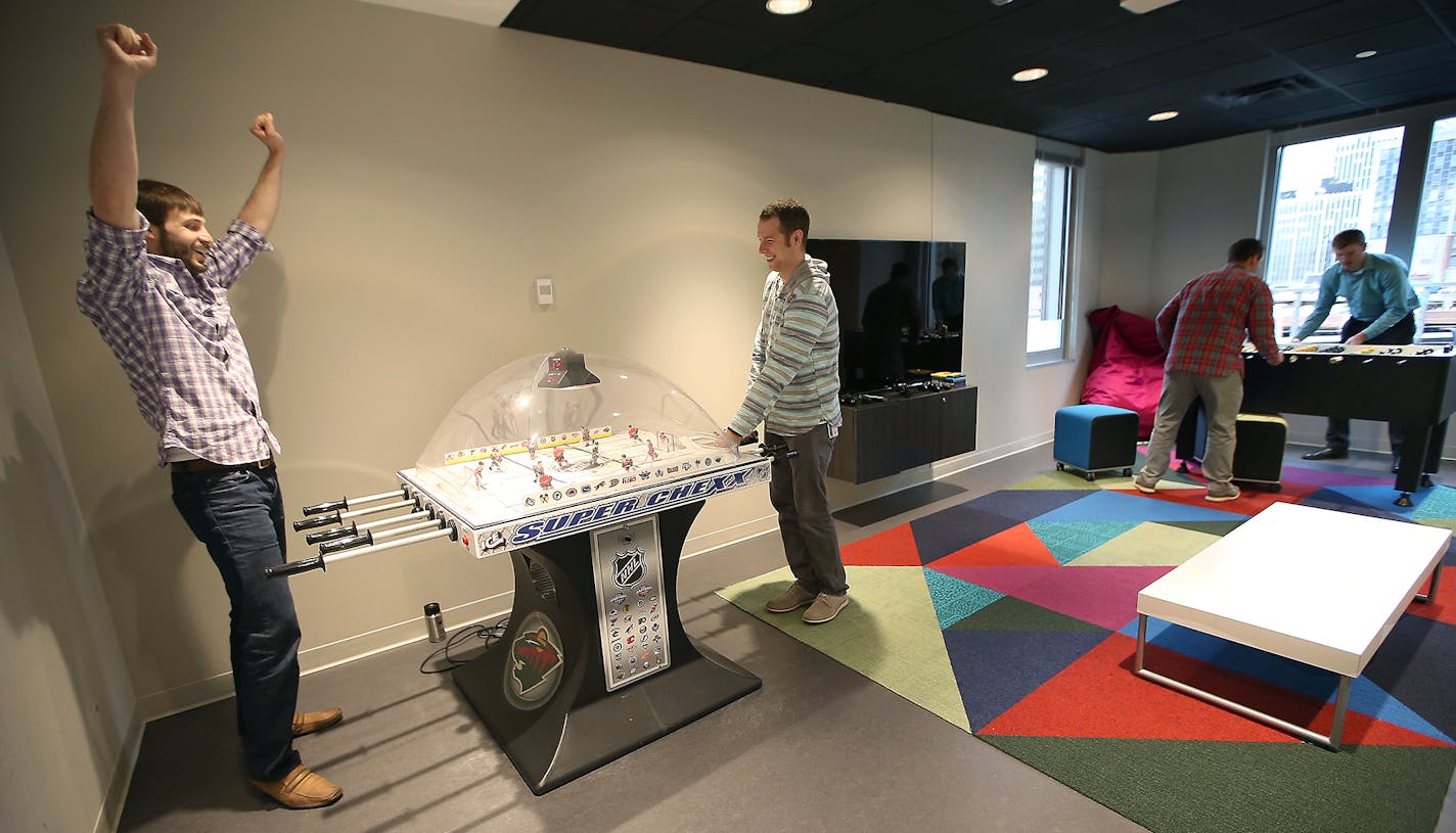 Ivan Anheluk, cq, left, and Mitch Rudolph took a break to play in the game room at SPS Commerce, Tuesday, May 19, 2015 in downtown Minneapolis, MN. ] (ELIZABETH FLORES/STAR TRIBUNE) ELIZABETH FLORES &#x2022; eflores@startribune.com