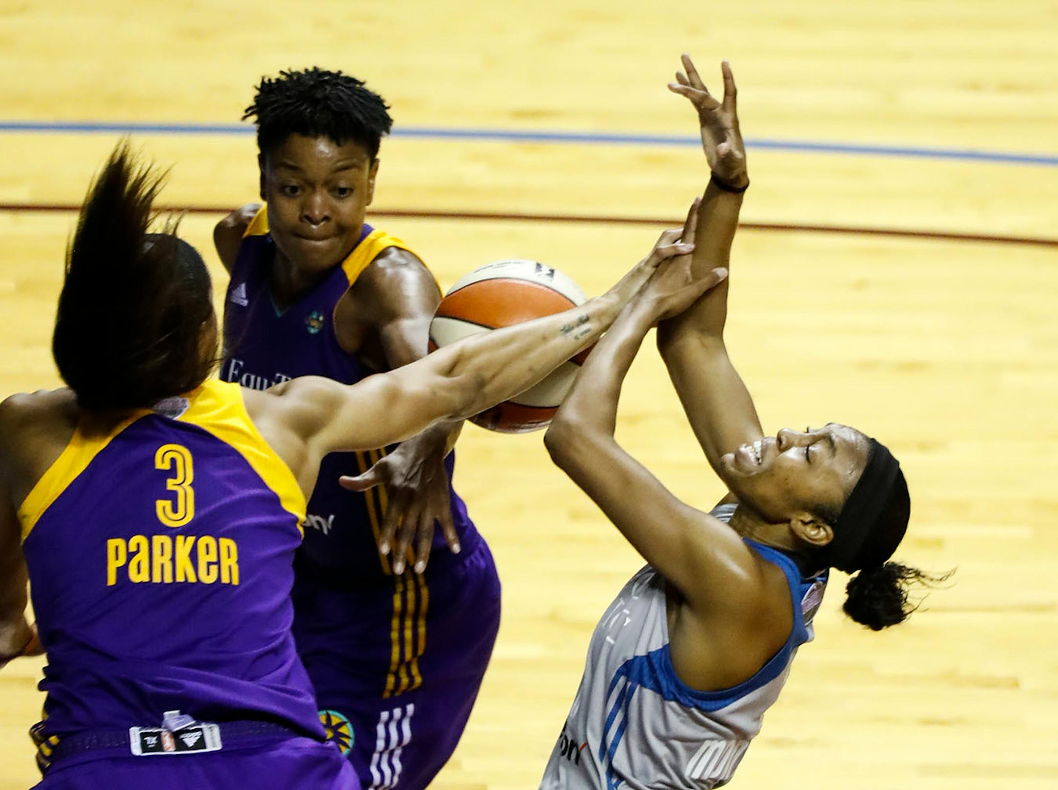 Minnesota Lynx guard Renee Montgomery (21) went for a shot that was shutdown by Los Angeles Sparks forward Candace Parker (3) in the second half. The Sparks won 85-84.