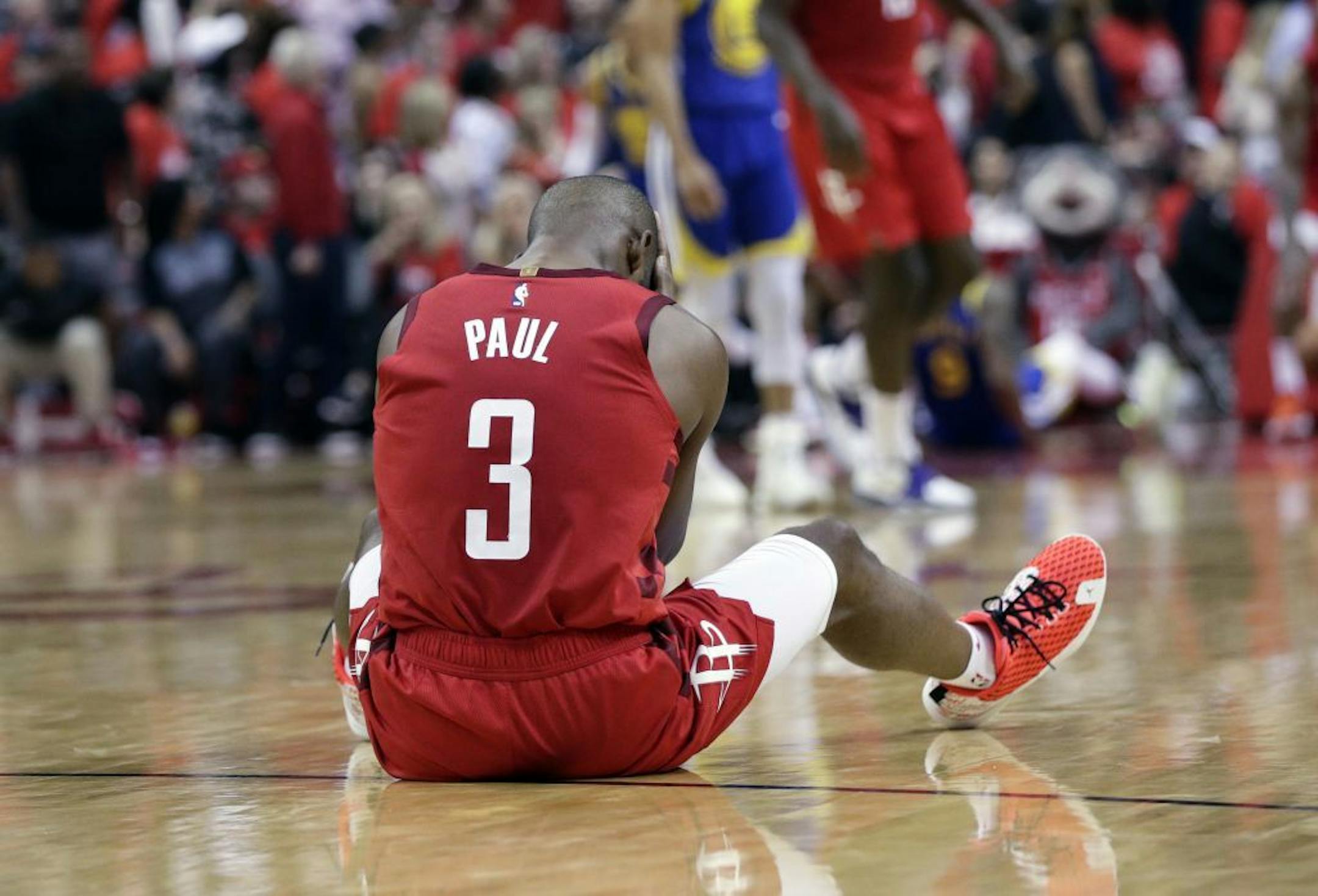 Houston Rockets guard Chris Paul sits on the court following a play during the second half in Game 6 of the team's second-round NBA basketball playoff series against the Golden State Warriors, Friday, May 10, 2019, in Houston. Golden State won 118-113, winning the series.