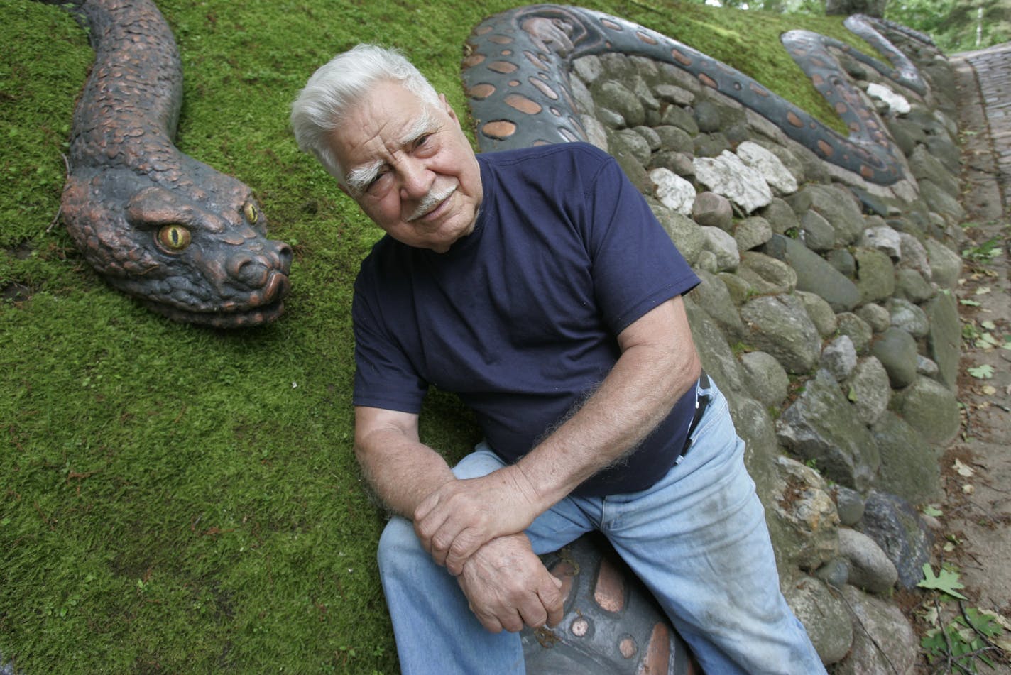 6/9/2005 Eaqgan, MN.-- 84 yr. old Anthony Caponi has created an Art Park over the past 14 years since he retired from McAlister College. Here he is with the snake that was finished the end of last October. The park has an outdoor amphitheater with Shakespear performances as well as chamber and orchestra performances. Beautiful ground of sculpture, walking and resting areas witha long distance view of the Minneapolis skyline. A must see. ORG XMIT: MIN2012120417025671