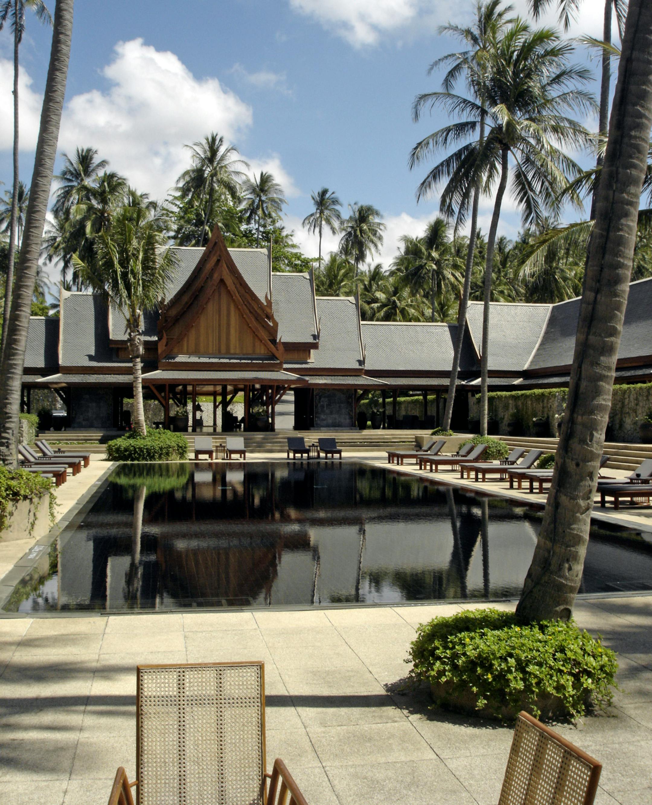 One of many black-tiled swimming pools at Amanpuri, a five-star resort on Phuket Island north of Patong. The staff-to-guest ratio here is reported to be seven-to-one, and the top villa rents for $7,000 per night.