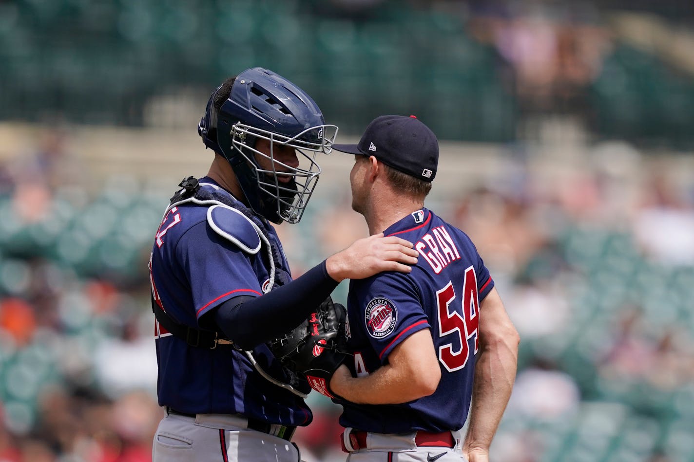 Minnesota Twins catcher Gary Sanchez talks with starting pitcher Sonny Gray during the fourth inning of a baseball game against the Detroit Tigers, Sunday, July 24, 2022, in Detroit. (AP Photo/Carlos Osorio)