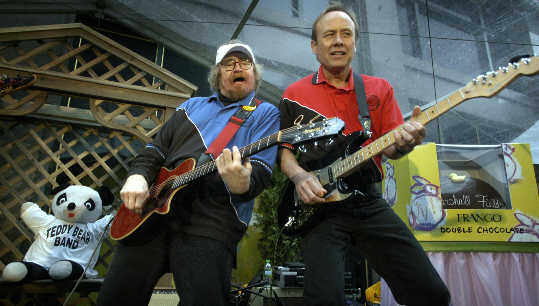 Ron Gustafson and Don Paulson jamming it.
GENERAL INFORMATION: MINNEAPOLIS, MN. 4/19/2003: The Teddy Bear Band is a rather scraggly-looking group, consisting of a couple of former rock musicians and a teacher. Their hair is long, some have unshaven faces, and at 50+ years each, they're old enough to be grandfathers to most of their audience. But they've been thrilling kids with their music for more than18 years. We look at what makes them so enduring and endearing.