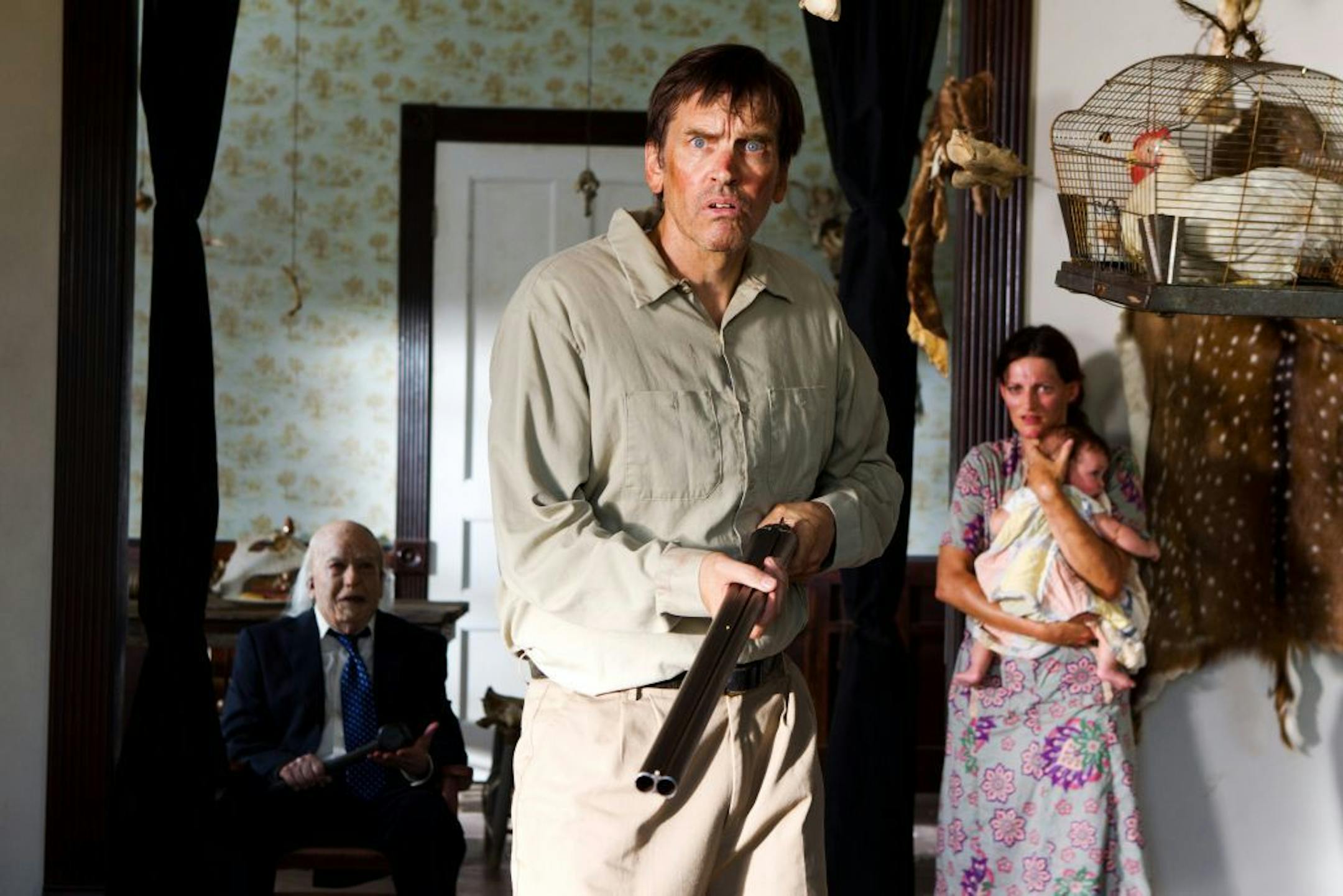 John Dugan, left, stars as Grandpa Sawyer, and Bill Moseley, center, as Drayton Sawyer, in "Texas Chainsaw 3-D."