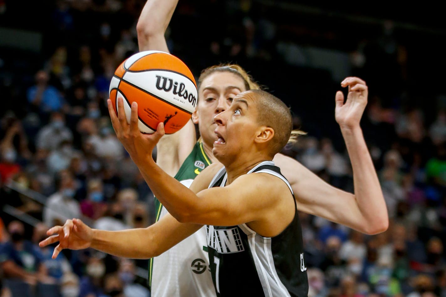 Minnesota Lynx guard Layshia Clarendon (7) drives to the basket past Seattle Storm forward Breanna Stewart (30) in the first quarter of a WNBA basketball game Tuesday, Aug. 24, 2021, in Minneapolis. (AP Photo/Bruce Kluckhohn)