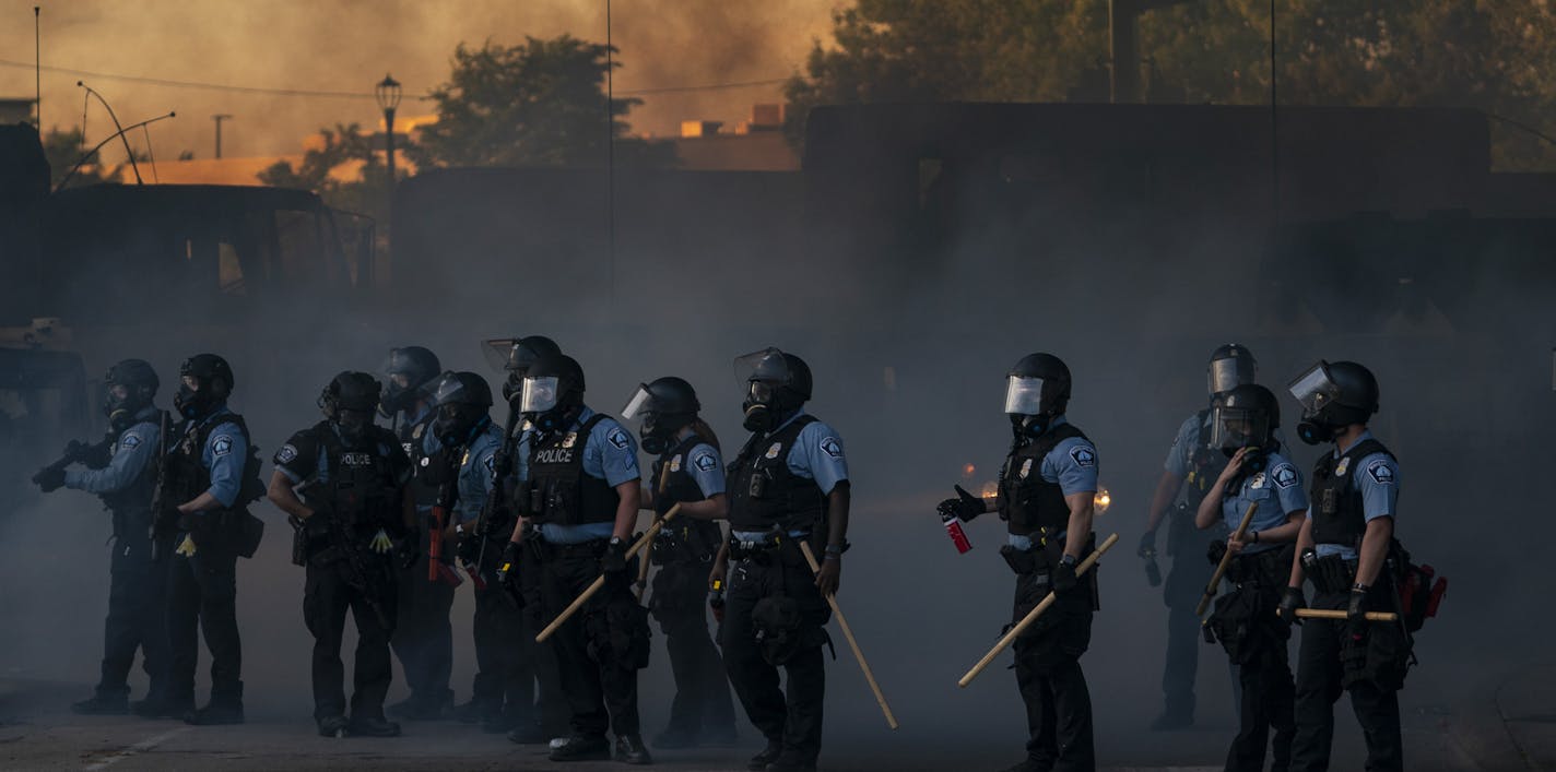 Police shot smoke bombs and tear gas into a crowd of people that had not left at the 8pm curfew near Lake Street under the Hiawatha Light Rail station in Minneapolis, Minn., on Friday, May 29, 2020. ] RENEE JONES SCHNEIDER renee.jones@startribune.com