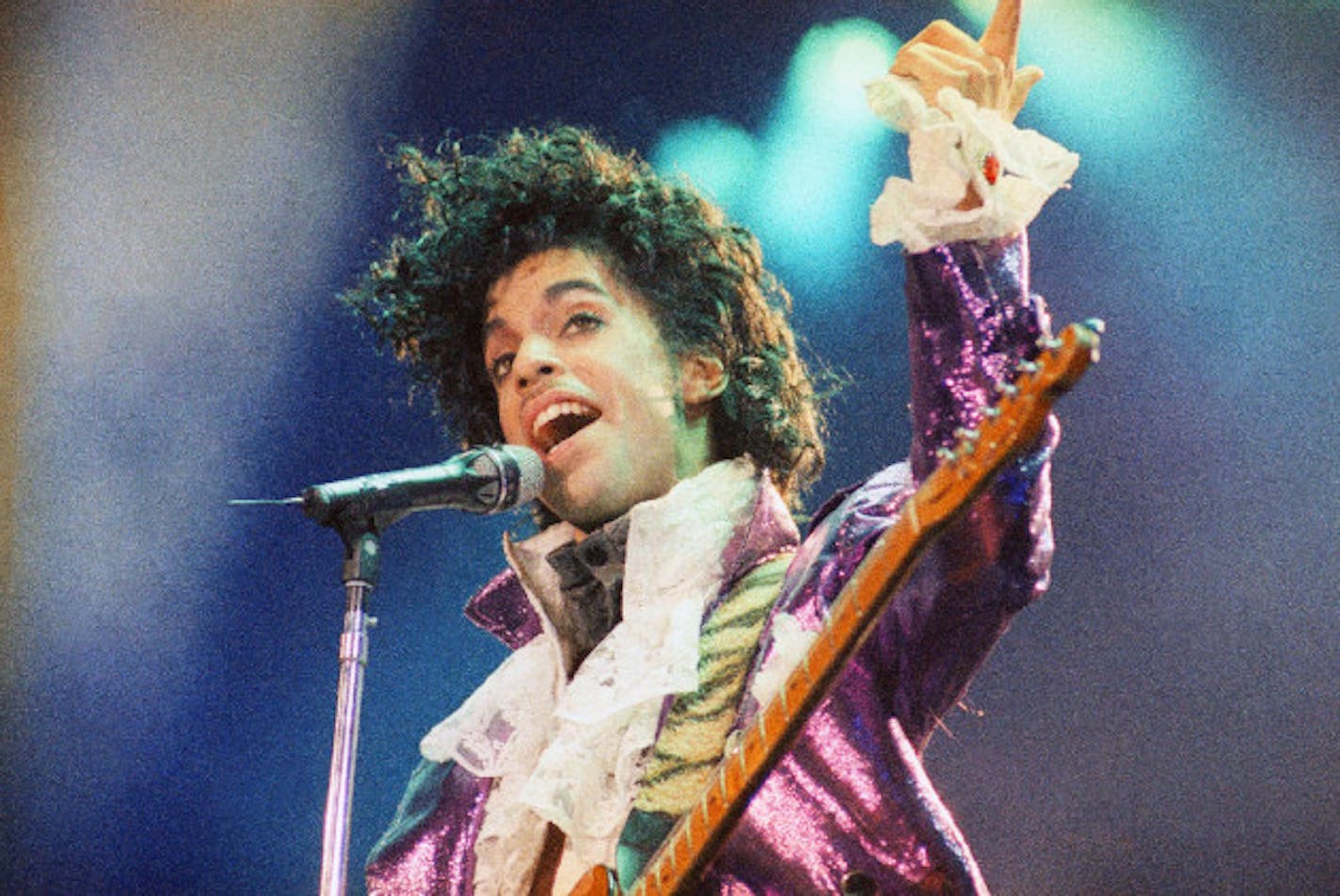 Prince playing to the dearly beloved circa 1985. / Associated Press, Liu Heung Shing