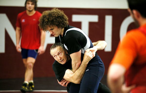 Coach Dan Chandler worked with Jordan Holm of wrestling techniques at Augsburg College Tuesday May 27, 2013 in Minneapolis , MN. Wrestling faces an im